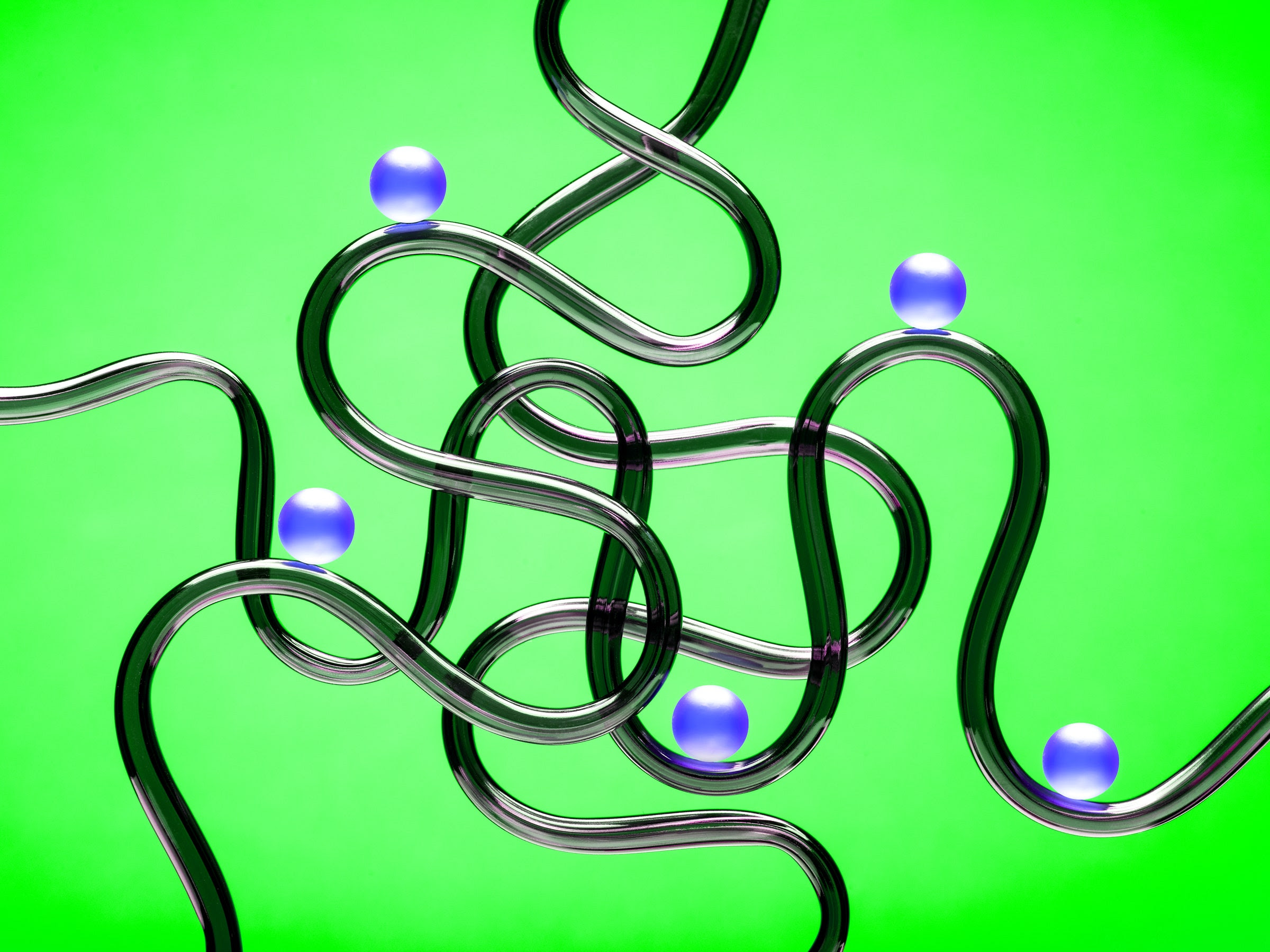 5 blue balls riding on 5 randomly arranged curved black tubes against a bright green backdrop