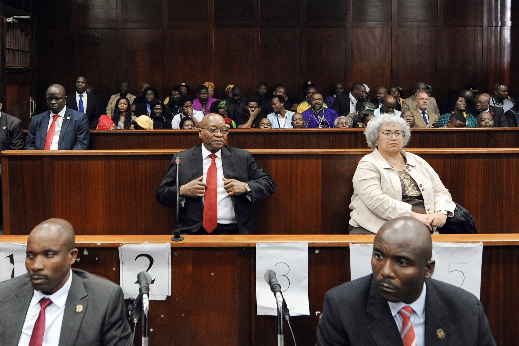 Jacob Zuma, center, the former president of South Africa, appeared in court in Durban this month for a hearing on corruption charges. Credit Felix Dlangamandla/Agence France-Presse — Getty Images 