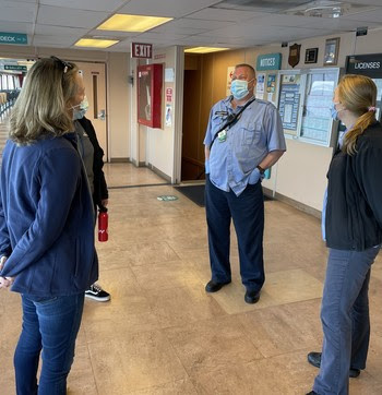 Photo of Patty Rubstello talking to crewmembers aboard a ferry