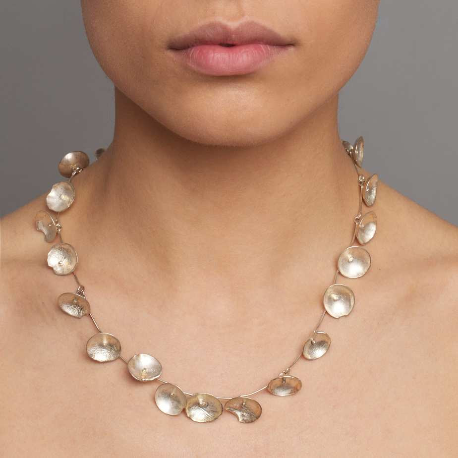 mosel wears large daisy necklace by shimara carlow at designyard contemporary jewellery dublin ireland