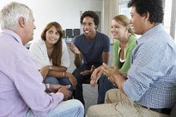 a photo of five people having a discussion
