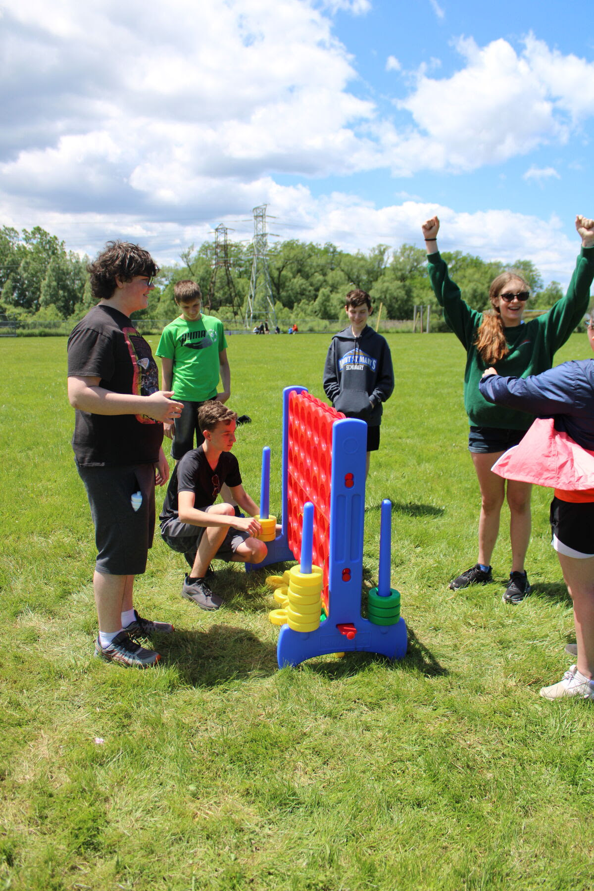 students play field day games outdoors on grass