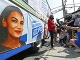 U.S. Rep. Alexandria Ocasio-Cortez, D, New York, center, meets a cluster of media beside a campaign truck plastered with her promotional material in Astoria, Queens, Tuesday, June 23, 2020, on primary election day in New York. (AP Photo/Kathy Willens) ** FILE **