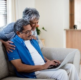 Couple check the status of their VA claim online with their laptop