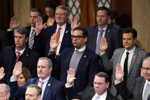 Rep. George Santos, R-N.Y., and Rep. Matt Gaetz, R-Fla., are sworn in by Speaker of the House Kevin McCarthy of Calif., as members of the 118th Congress in Washington, early Saturday, Jan. 7, 2023.
