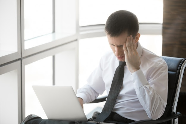 Young business man having headache