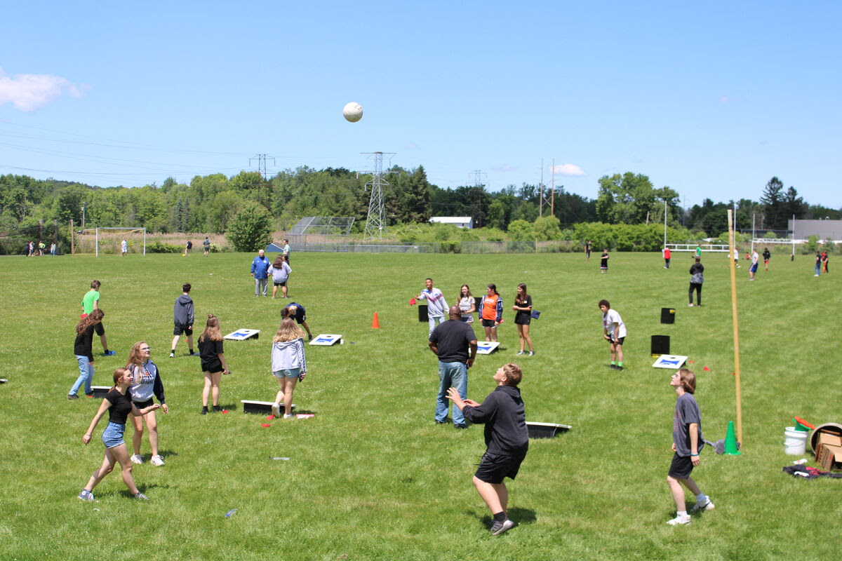students play field day games outdoors on grass
