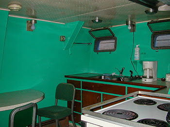 The basic green-colored galley aboard the Survey Vessel Steelhead is shown.