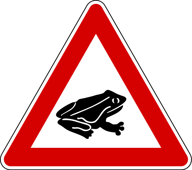 A red and white triangle sign with a frogDescription automatically generated with low confidence