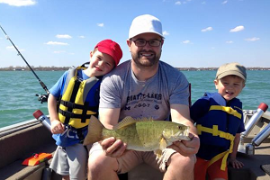 Brad Utrup, who works in the DNR Fisheries Division's Research Section, shows off a fish he and his young sons caught