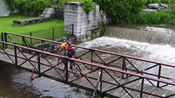 Person on biking riding over a bridge