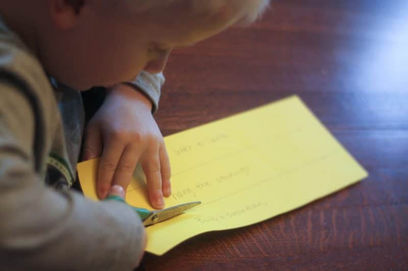 Cutting paper is one of these great cutting activities for kids to learn scissors skills