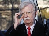 In this March 5, 2019, file photo, then-National Security Adviser John Bolton adjusts his glasses before an interview at the White House in Washington. (AP Photo/Jacquelyn Martin) ** FILE **