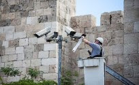A technician fixing security cameras located near the old city of Jerusalem.