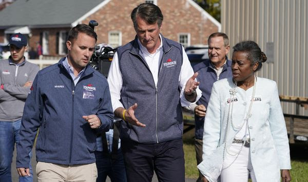 Republican gubernatorial candidate Glenn Youngkin, center, speaks with running mates, attorney general candidate, Jason Miyares, left, and lieutenant governor candidate Winsome Sears, right, as they walk from a rally in Fredericksburg, Va., Saturday, Oct. 30, 2021. Youngkin will face Democrat former Gov. Terry McAuliffe in the November election. (AP Photo/Steve Helber, File)