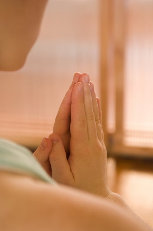 close up of hands in prayer in yoga