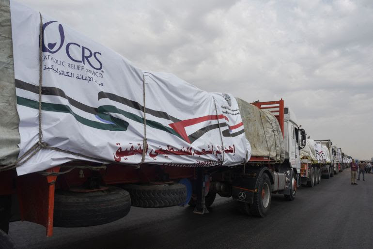 Trucks carrying humanitarian aid to Palestinians, wait on the desert road (Cairo - Ismailia) on their way to the Rafah border crossing to enter Gaza