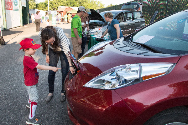 people at an electric vehicle event