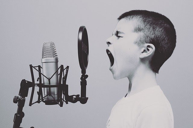 boy singing into microphone