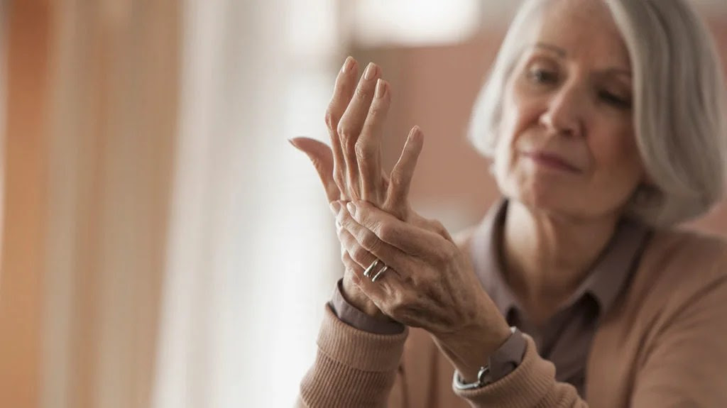 a woman with pain in her hand due to small fiber neuropathy