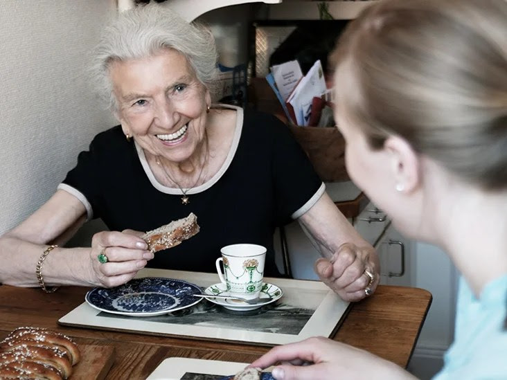 older woman drinking tea with young daughter