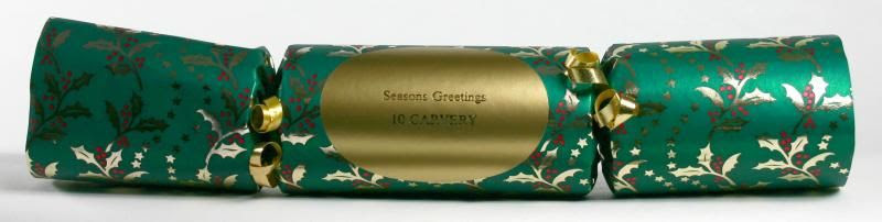 Green and gold Christmas cracker with label reading Season's Greetings 10 Carvery