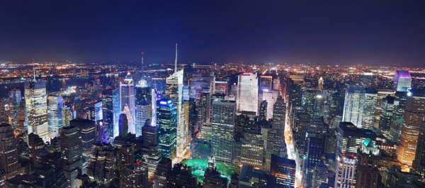 New York City Manhattan Times Square panorama aerial view at night with office building skyscrapers skyline illuminated by Hudson River.