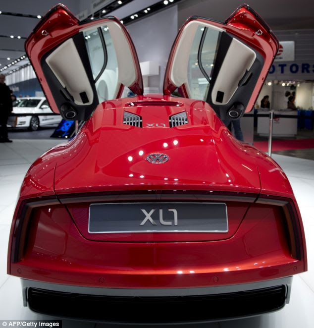 The XL1's edgy design is intended to reduce drag and it features 'scissor doors' (pictured) famously featured in the DeLorean DMC-12, which was used in the Back to the Future films
