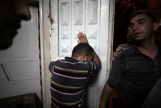 Palestinians mourn in the morgue of Shifa hospital in Gaza City.