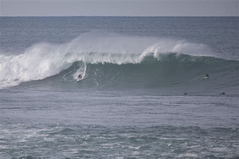 Surfers riding waves in Guethary