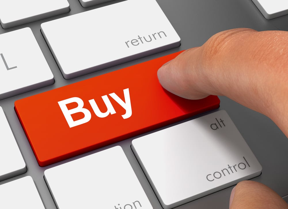 Person pressing a buy key Person pressing a buy key
