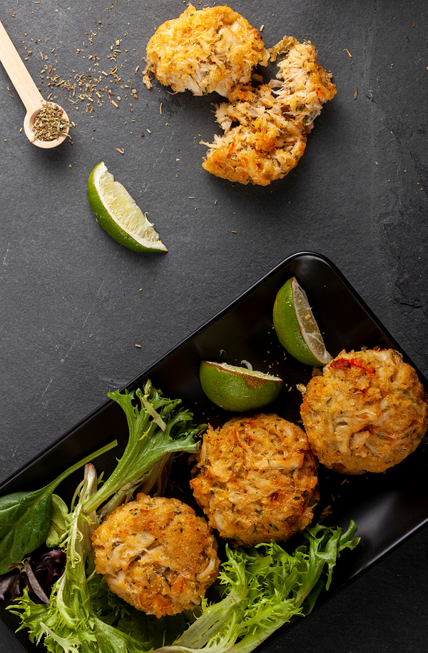 fresh crab cakes on a board