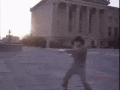 Rocky at the top of the steps shadow boxing and being cheered on by a crowd of children GIF