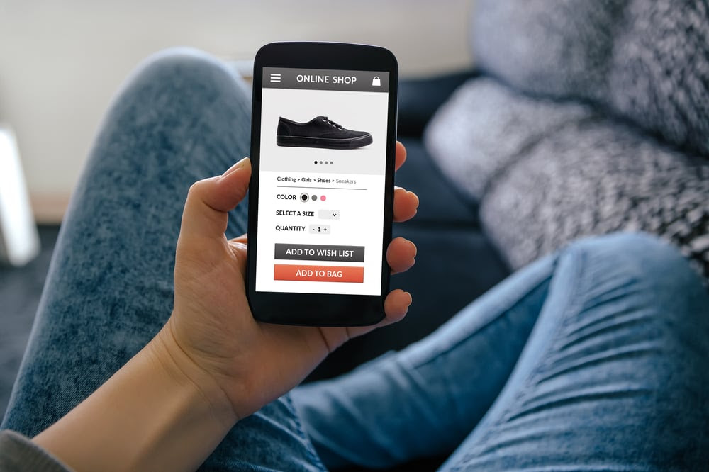 Person shopping for shoes on their phone Person shopping for shoes on their phone