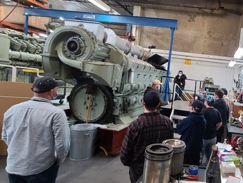 People working on a ferry engine