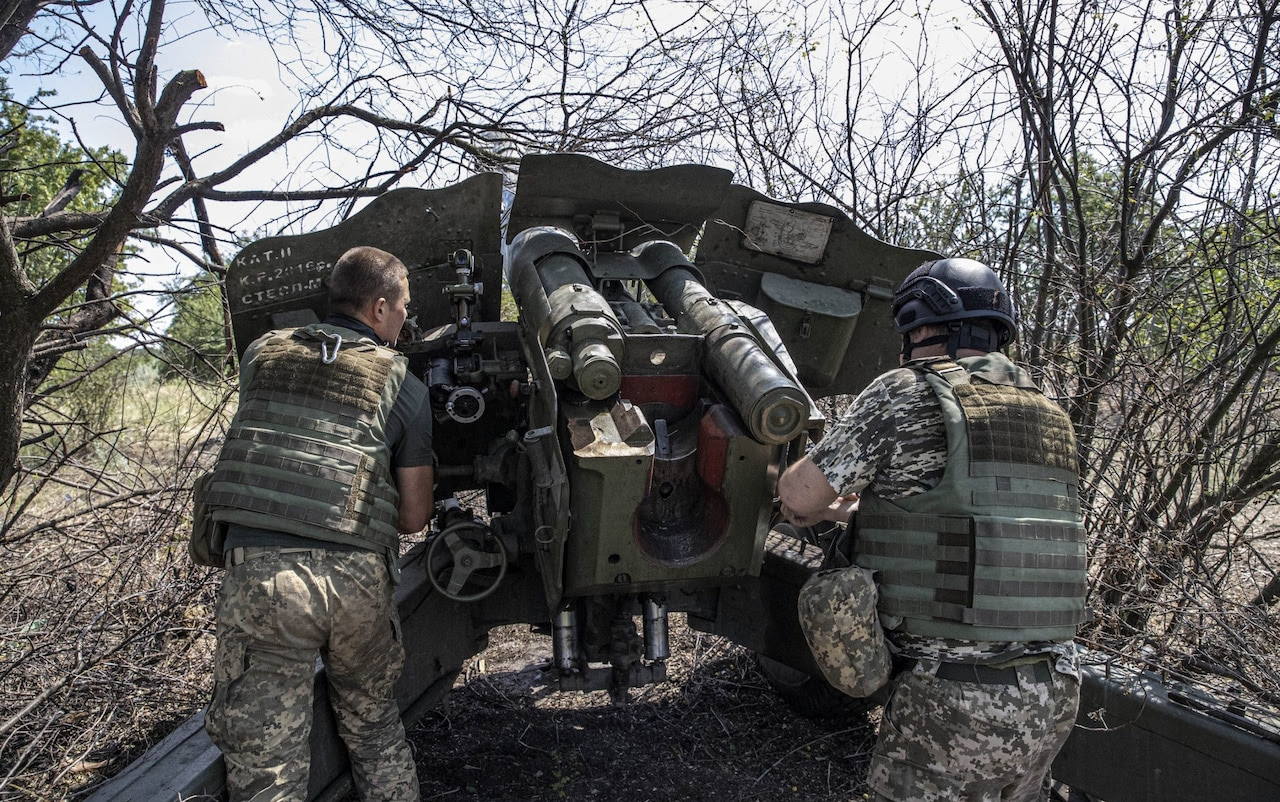 Ukrainian soldiers check weapons and equipment before they return to fighting on the front line in Kherson.