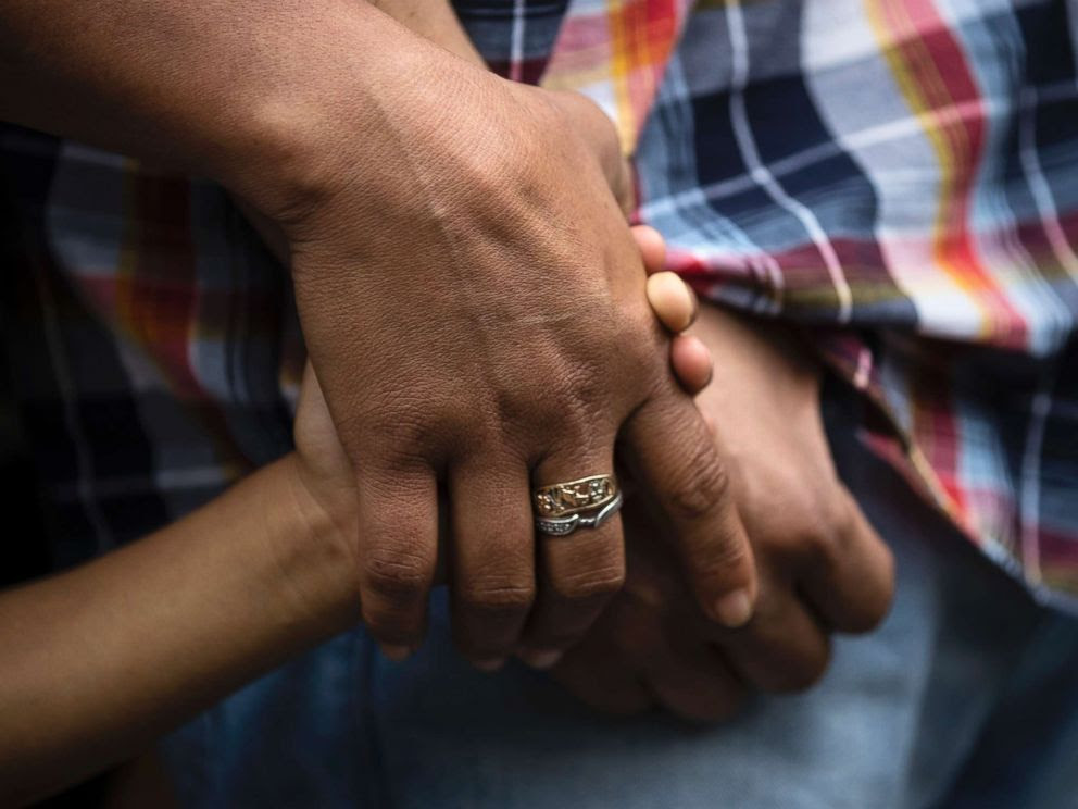 PHOTO: Alma Lopez holds her son Javiers and husband Javier Flores Garcias hands during a news conference outside of the Arch Street United Methodist Church in Philadelphia, Oct. 11, 2017. 