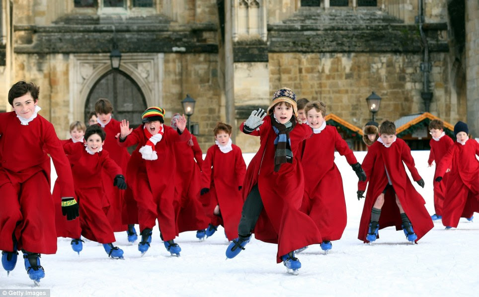 Skates re-choir-ed: Young choristers from Winchester Cathedral don ice-skates to enjoy the artificial rink set up beside the cathedral earlier today