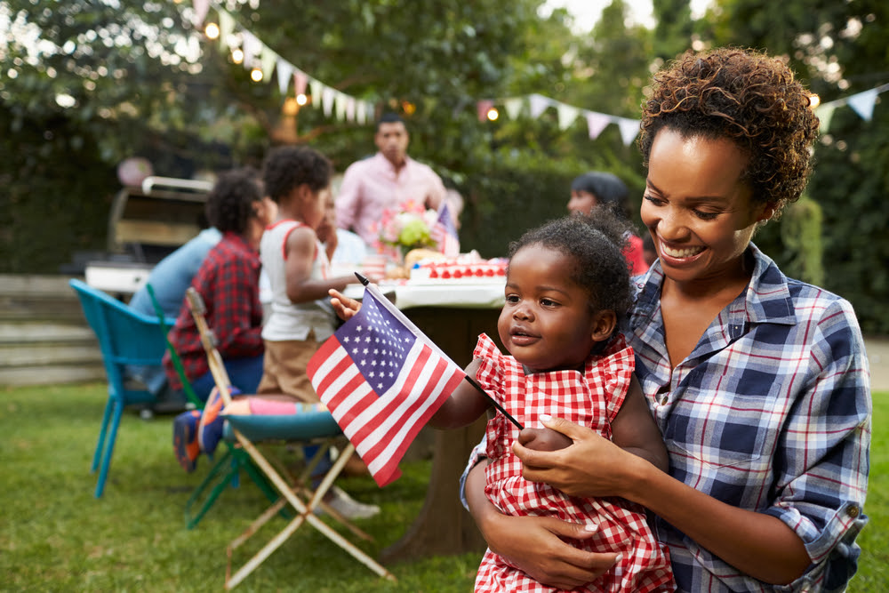 african american family having a backyard picnic on the 4th of July