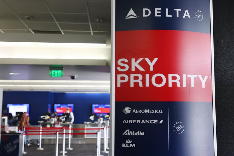 LOS ANGELES, CALIFORNIA - AUGUST 25: A Delta Air Lines sign is displayed on the departures level at Los Angeles International Airport (LAX) on August 25, 2021 in Los Angeles, California. Delta is increasing health insurance premiums for employees who are unvaccinated by $200 per month to cover higher costs of Covid-related care. (Photo by Mario Tama/Getty Images)