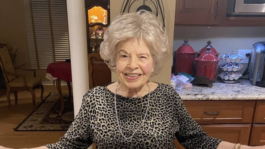Madeline Paldo, 100, smiling in her home