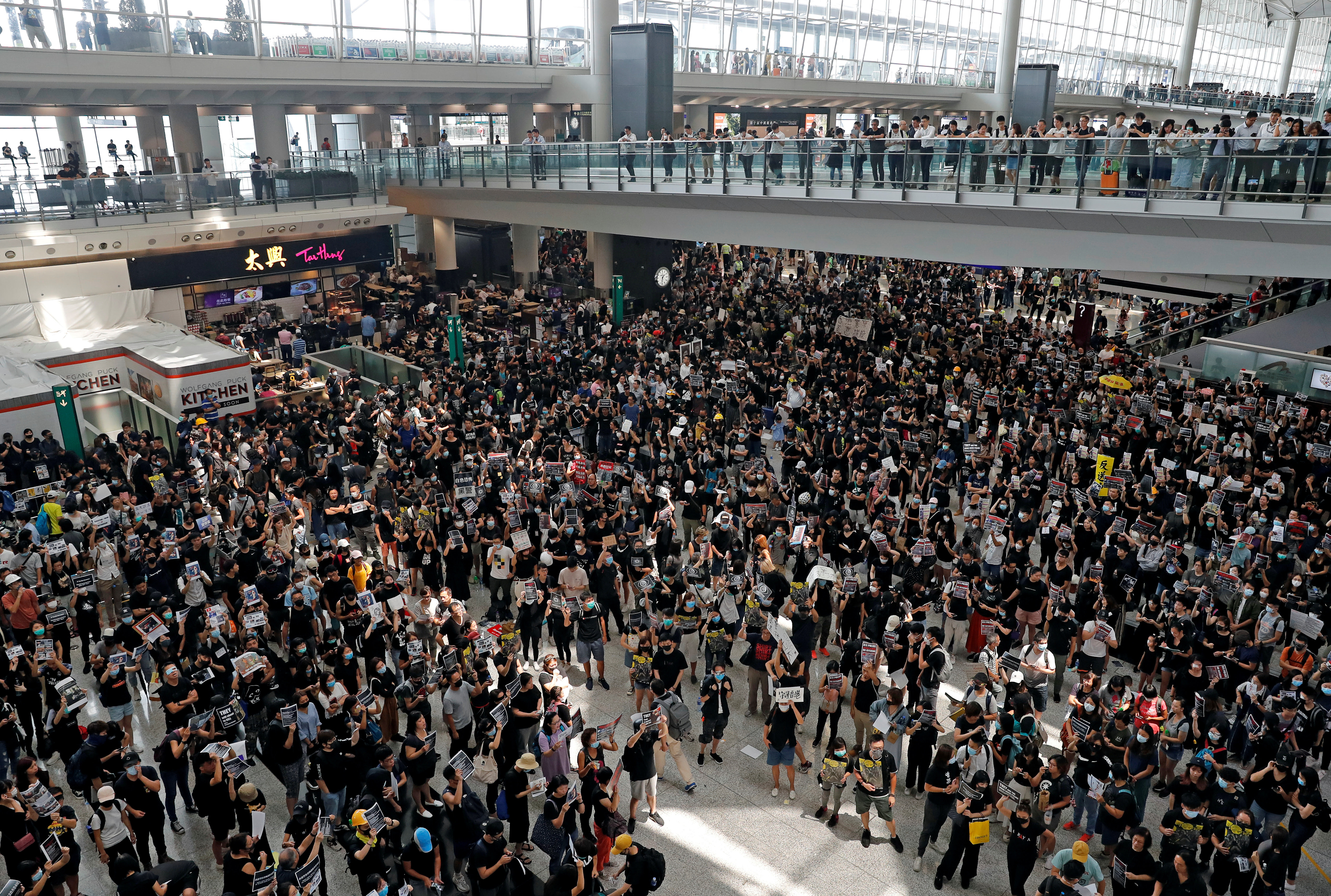 Thousands of demonstrators sit in the main terminal of Hong Kong's international airport