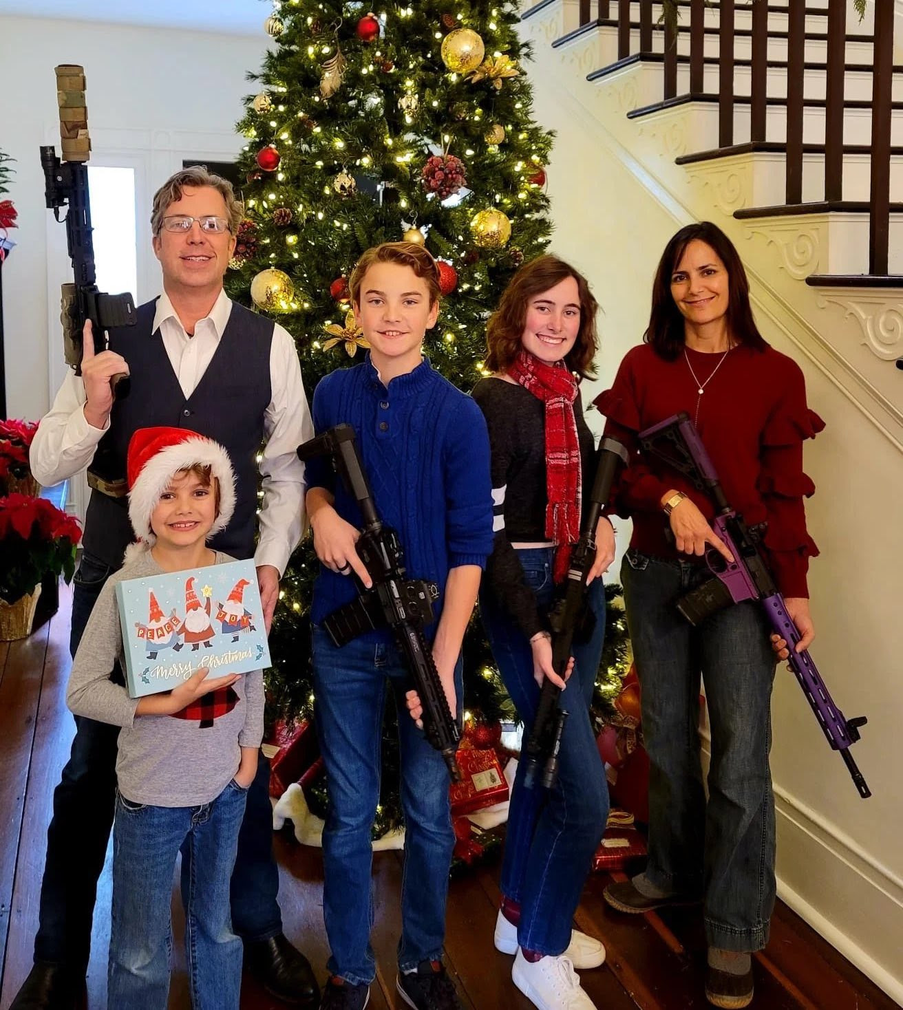 Photo of Rep Ogles' family holding assault weapons in front of a holiday tree