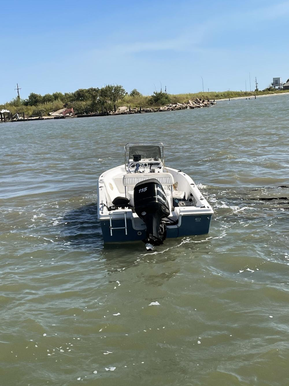 A 17-foot pleasure craft rests aground on rocks north of the Bolivar Ferry Landing near Galveston, Texas, Oct. 20, 2022. A Coast Guard Station Galveston 29-foot Response Boat–Small crew safely removed two boaters from the vessel, which was taking on water. (U.S. Coast Guard photo by Petty Officer 3rd Class Chris San Nicolas)