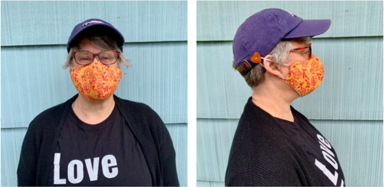 Woman with baseball cap from the side wearing face mask with elastic around a button sewn onto baseball cap