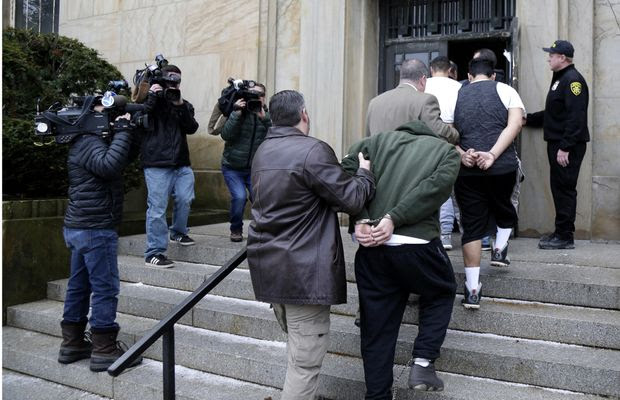 In this Jan. 11, 2018, file photo, suspected members of the MS-13 gang are escorted to their arraignment in Mineola, N.Y. A sweep of alleged MS-13 gang members on Long Island has racked up impressive arrest totals but also left unanswered questions. Since May, federal authorities say they've arrested more than 220 members of the notorious street gang. But authorities have largely declined multiple requests by for even the most basic information about the arrests. (AP Photo/Seth Wenig, File)