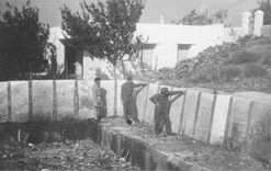 In Salonika, British officers examine a swimming pool constructed by German forces out of Jewish tombstones (1945-46). USHMM, courtesy of Beit Lohamei Haghetaot