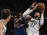 Utah Jazz center Rudy Gobert (27) shoots as New York Knicks forward Bobby Portis (1) defends during the second half of an NBA basketball game in New York, Wednesday, March 4, 2020. (AP Photo/Sarah Stier)