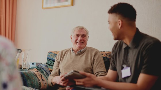 Man at home with visiting care worker