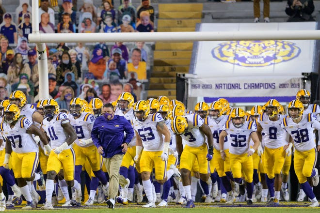 LSU head coach Ed Orgeron leads his team on the field before the game against Alabama in Baton Rouge, La., last Saturday.